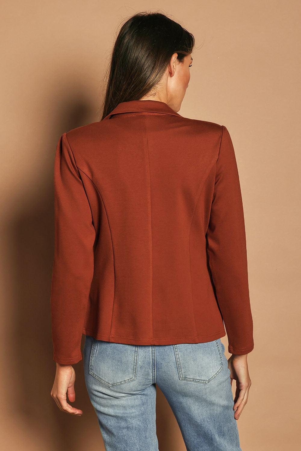 Model Madeline wearing size 10 of The Ponte Blazer in colour Ochre, from the back