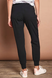 Model Madeline wearing size 10 of The Basic Keeper Pant in colour Black (Black), from the back