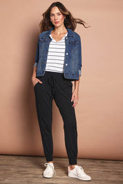 Model Madeline wearing size 10 of The Basic Keeper Pant in colour Black (Black), from the front, showing the whole outfit