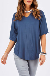 Model Clementine wearing size 10 of The Stella Tee in colour Blue (Blue), from the front, cropped image