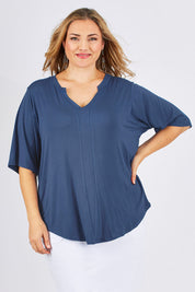 Model Ljubenka wearing size 18 of The Stella Tee in colour Blue (Blue), from the front, cropped image