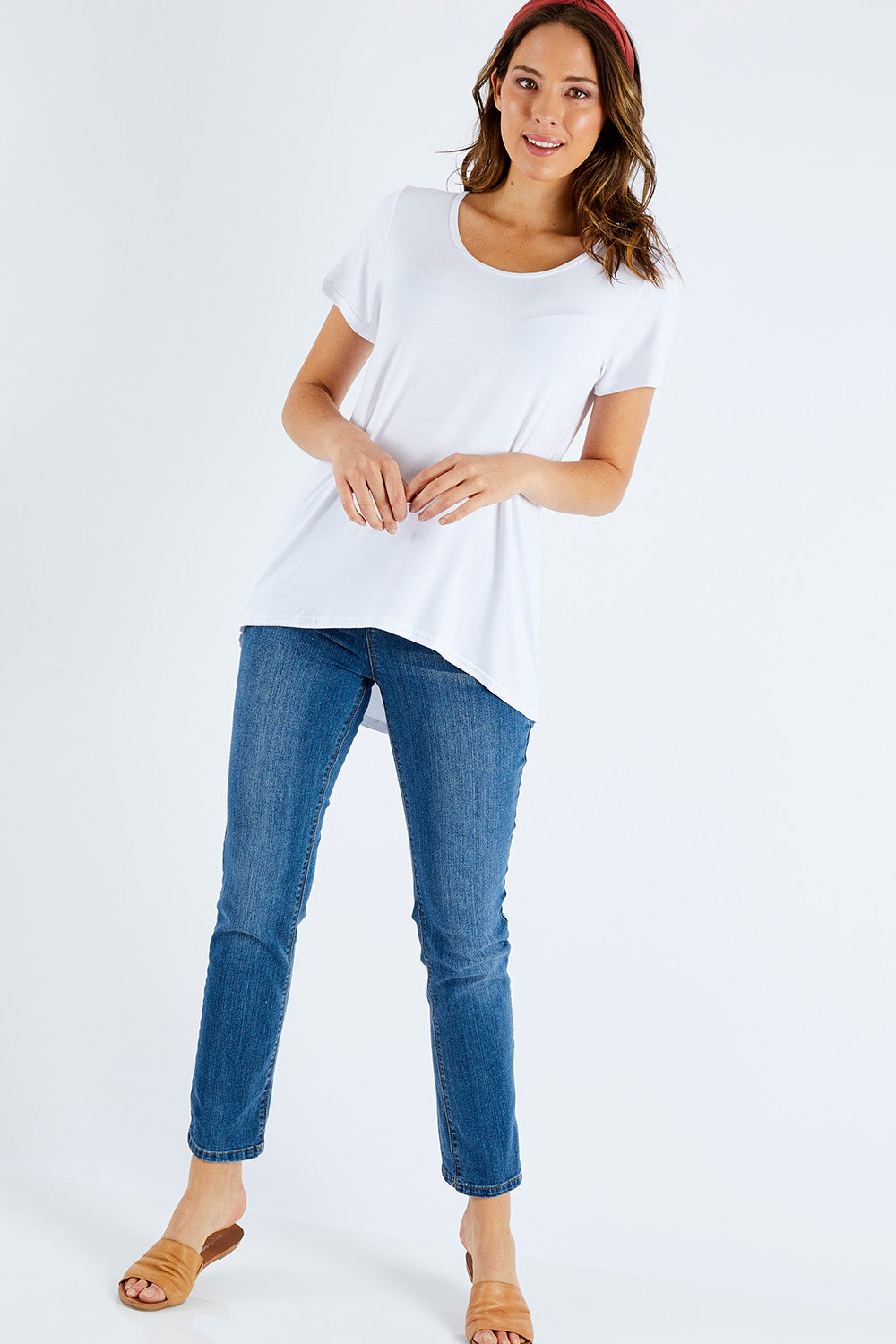 Model Madeline wearing size 10 of The Round Neck Bamboo Tee in colour White (White), from the front, showing the whole outfit
