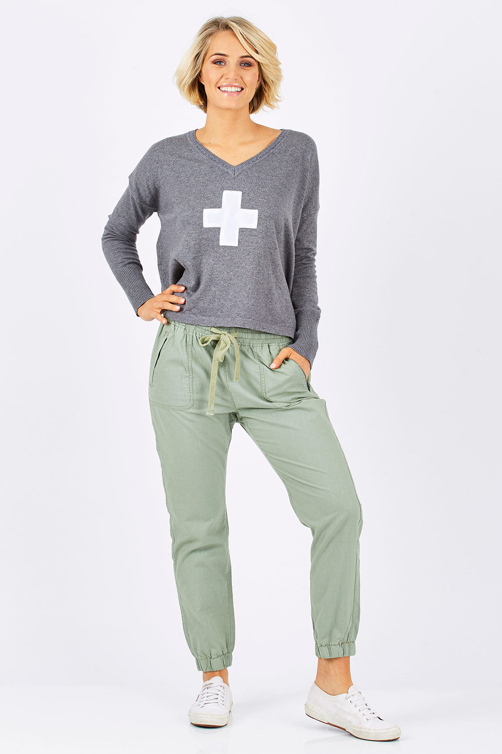 Model Emma wearing size 10 of The Weekender Pant in colour Khaki (Green), from the front, showing the whole outfit