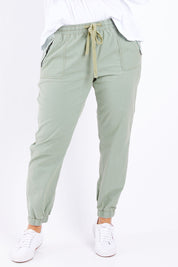 Model Laura wearing size 14 of The Weekender Pant in colour Khaki (Green), from the front, cropped image