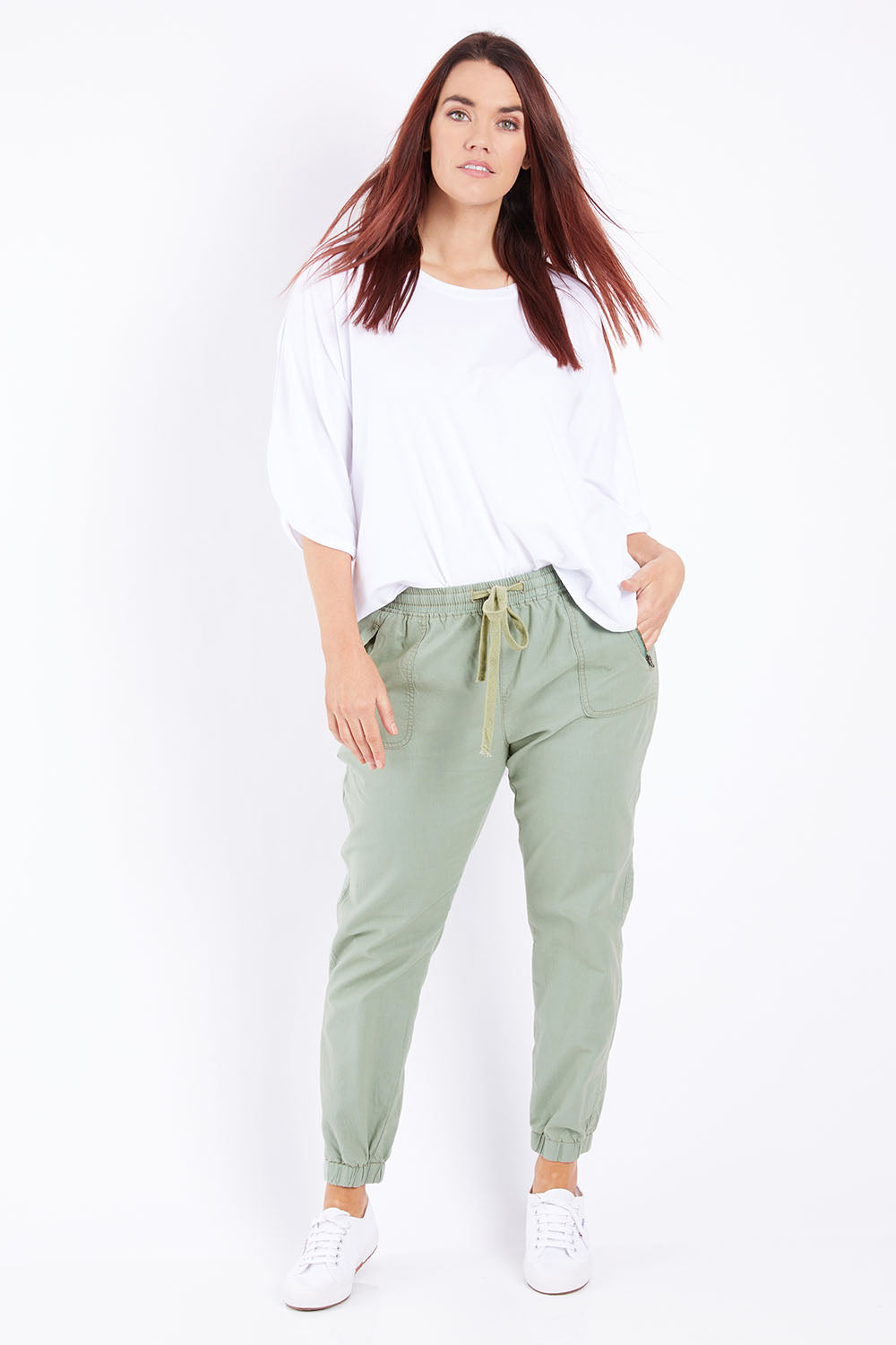 Model Laura wearing size 14 of The Weekender Pant in colour Khaki (Green), from the front, showing the whole outfit