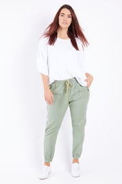 Model Laura wearing size 14 of The Weekender Pant in colour Khaki (Green), from the front, showing the whole outfit