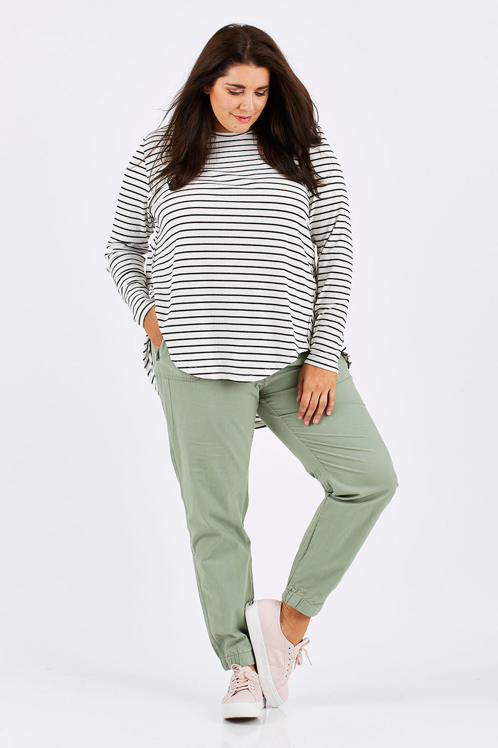 Model Mae wearing size 18 of The Weekender Pant in colour Khaki (Green), from the front, showing the whole outfit