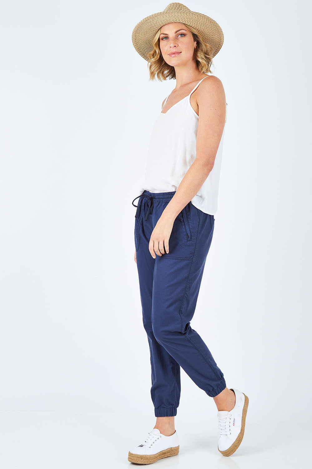 Model Chelsea wearing size 10 of The Weekender Pant in colour Navy (Blue), from the front, showing the whole outfit