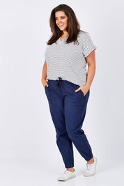 Model Mae wearing size 16 of The Weekender Pant in colour Navy (Blue), from the front, showing the whole outfit