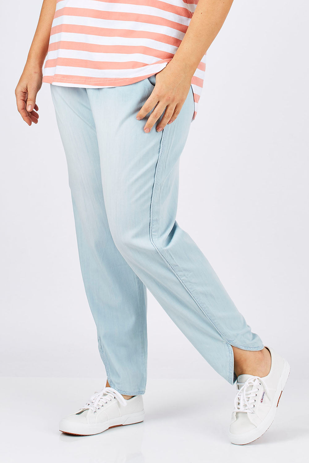 Model Ljubenka wearing size 18 of The Chambray Curved Hem Pant in colour Chambray (Blue), from the front, cropped image