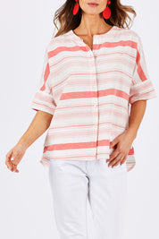 Model Clementine wearing size 10 of The Stripe Button Through Top in colour Coral (Pink), from the front, cropped image