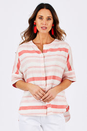 Model Clementine wearing size 10 of The Stripe Button Through Top in colour Coral (Pink), from the front, cropped image