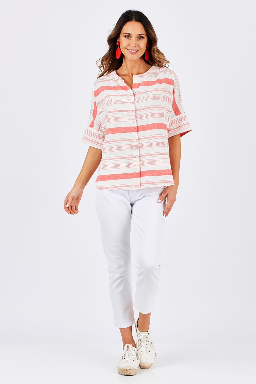 Model Clementine wearing size 10 of The Stripe Button Through Top in colour Coral (Pink), from the front, showing the whole outfit