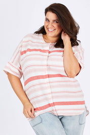 Model Mae wearing size 18 of The Stripe Button Through Top in colour Coral (Pink), from the front, cropped image