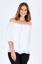 Model Riina wearing size 10 of The Double Layer Top in colour White (White), from the front, cropped image