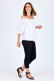 Model Riina wearing size 10 of The Double Layer Top in colour White (White), from the front, showing the whole outfit
