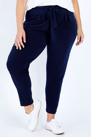 Model Jess wearing size 16 of The Comfort Pant in colour Navy (Blue), from the front, cropped image