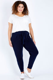 Model Jess wearing size 16 of The Comfort Pant in colour Navy (Blue), from the front, showing the whole outfit
