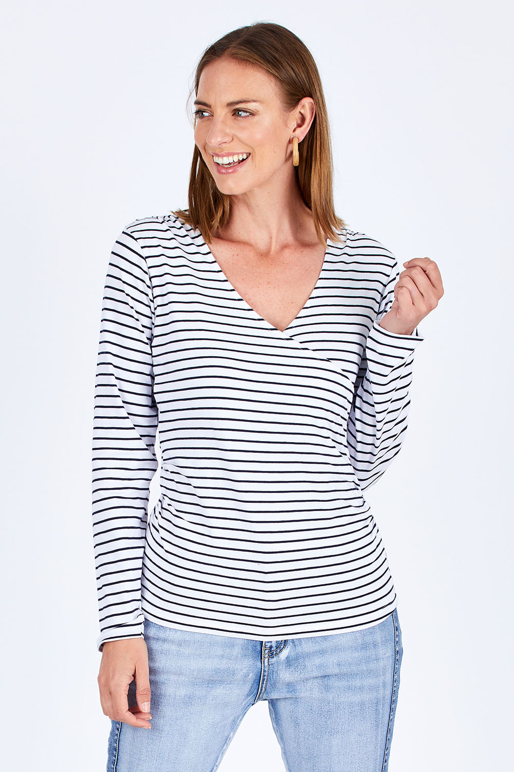 Model Riina wearing size 10 of The Wrap Jersey Top in colour NavyStripe (Blue), from the front, cropped image