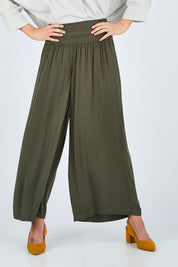 Model Chelsea wearing size 10 of The Wide Leg Relaxed Pant in colour Khaki (Green), from the front, cropped image