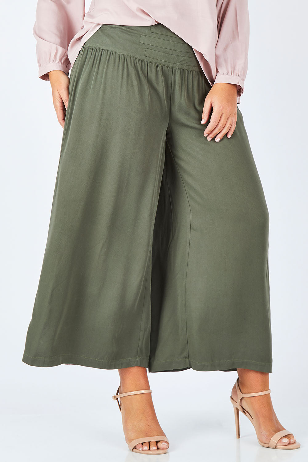 Model Fiona wearing size 16 of The Wide Leg Relaxed Pant in colour Khaki (Green), from the front, cropped image