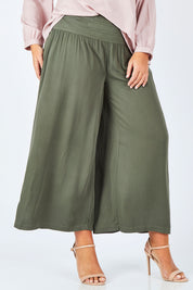 Model Fiona wearing size 16 of The Wide Leg Relaxed Pant in colour Khaki (Green), from the front, cropped image
