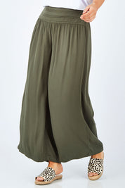 Model Laura wearing size 14 of The Wide Leg Relaxed Pant in colour Khaki (Green), from the front, cropped image