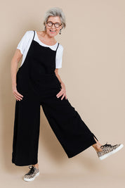 Model Elise wearing size 10 of The Easy Day Jumpsuit in colour Black (Black), from the front, showing the whole outfit