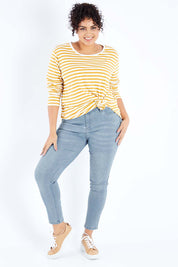 Model Sasha-Lee wearing size 16 of The Mid Rise Skinny Jean in colour Lightdenim (Blue), from the front, showing the whole outfit