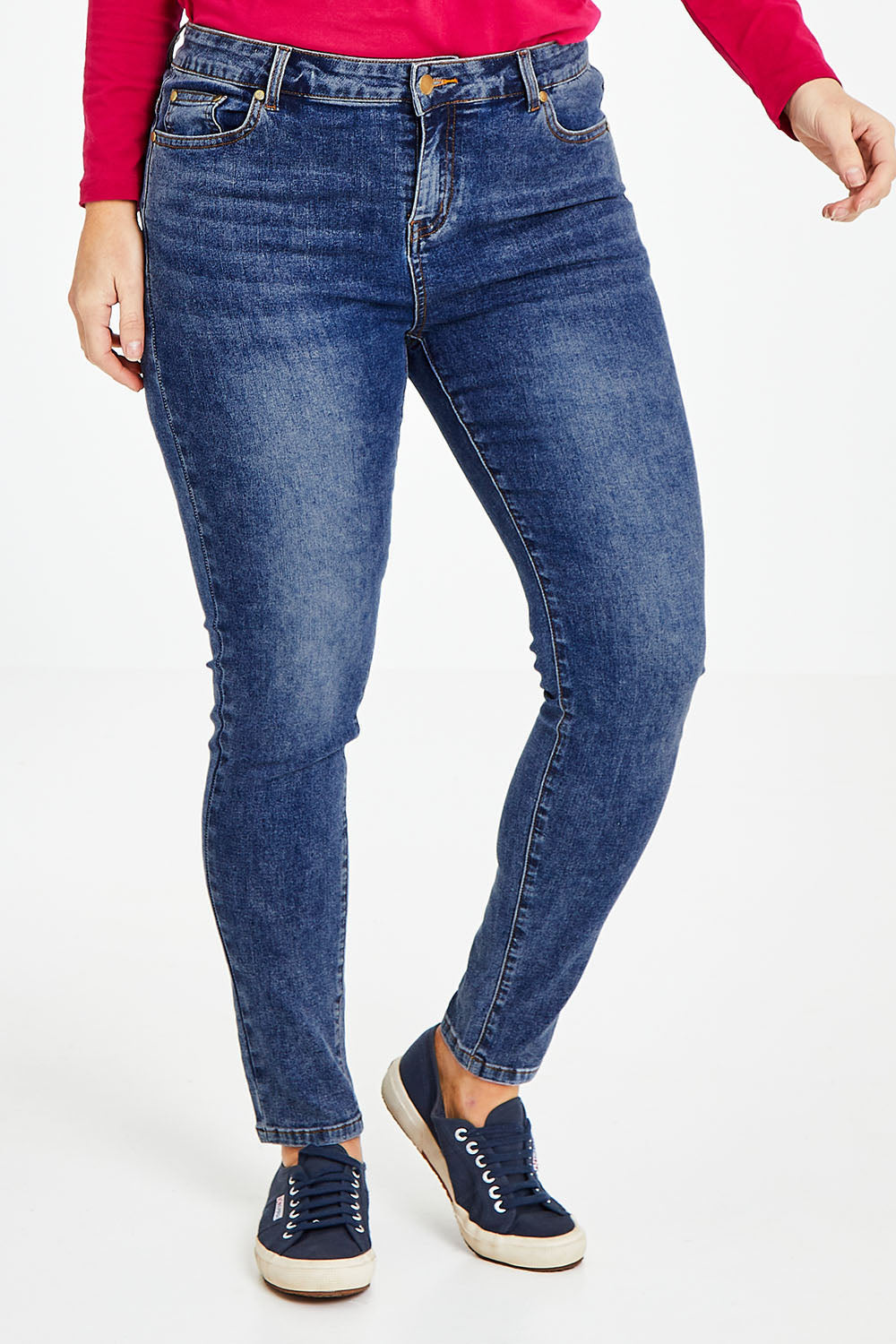 Model Laura wearing size 14 of The Mid Rise Skinny Jean in colour Washdenim (Blue), from the front, cropped image