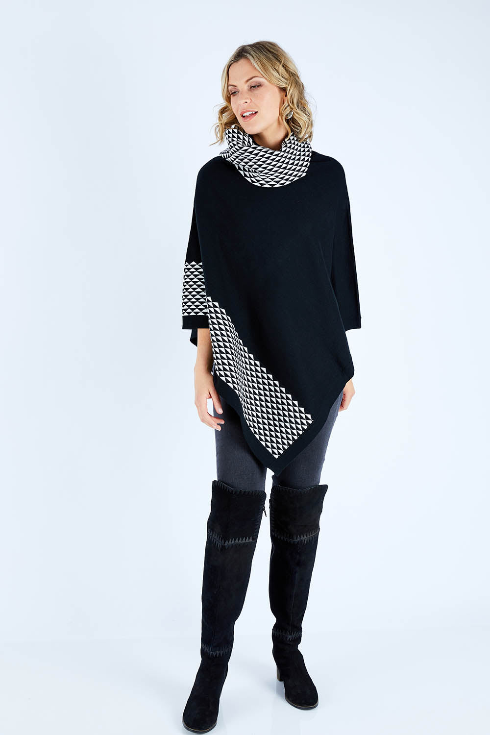Model Chelsea wearing size S-M of The Patterned Removable Roll Neck Poncho in colour Blackprint (Black), from the front, showing the whole outfit