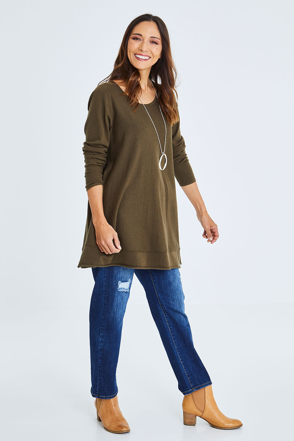 Model Cara wearing size S of The Swing Knit in colour Khaki (Green), from the front, showing the whole outfit