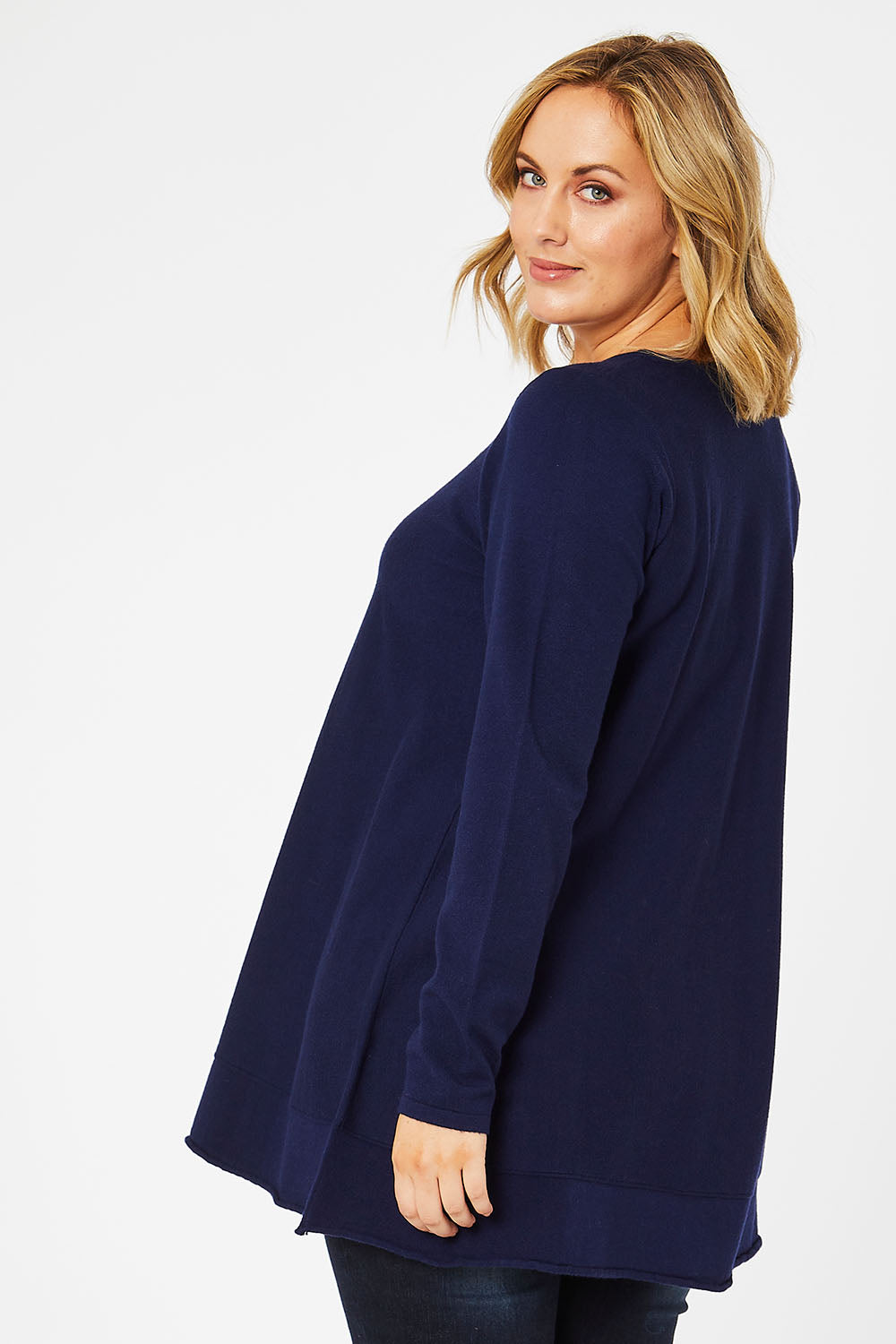 Model Jess wearing size L of The Swing Knit in colour Navy (Blue), from the back