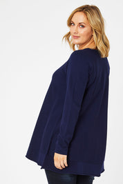 Model Jess wearing size L of The Swing Knit in colour Navy (Blue), from the back