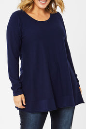 Model Jess wearing size L of The Swing Knit in colour Navy (Blue), from the front, cropped image