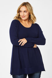 Model Jess wearing size L of The Swing Knit in colour Navy (Blue), from the front, cropped image