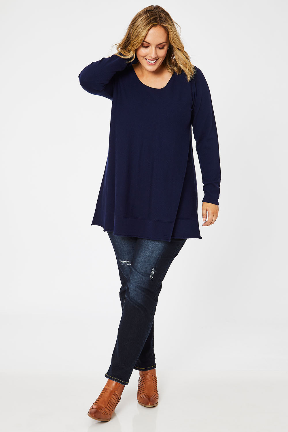 Model Jess wearing size L of The Swing Knit in colour Navy (Blue), from the front, showing the whole outfit