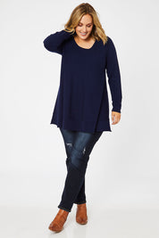 Model Jess wearing size L of The Swing Knit in colour Navy (Blue), from the front, showing the whole outfit