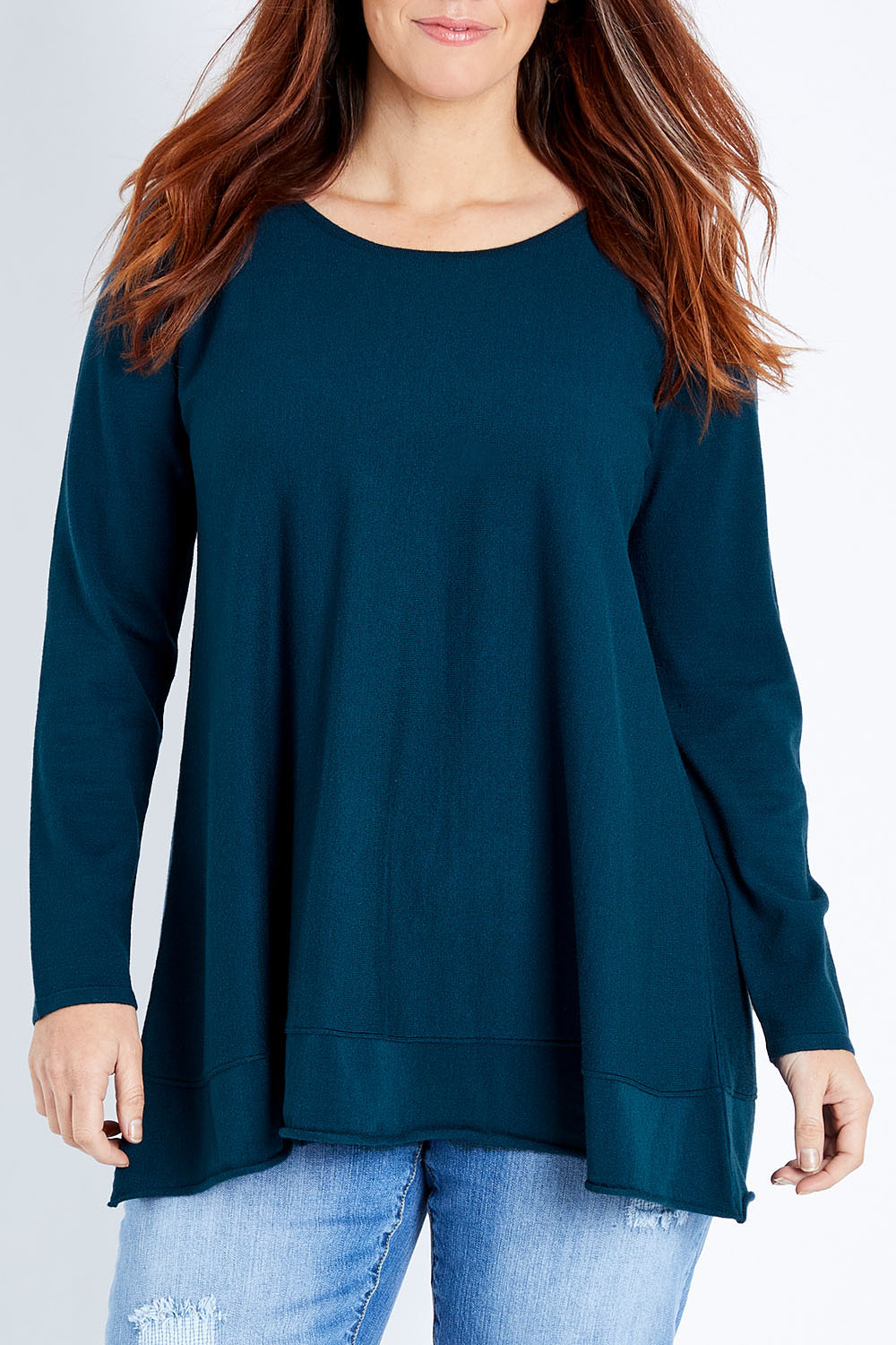 Model Laura wearing size M of The Swing Knit in colour Petrol (Blue), from the front, cropped image