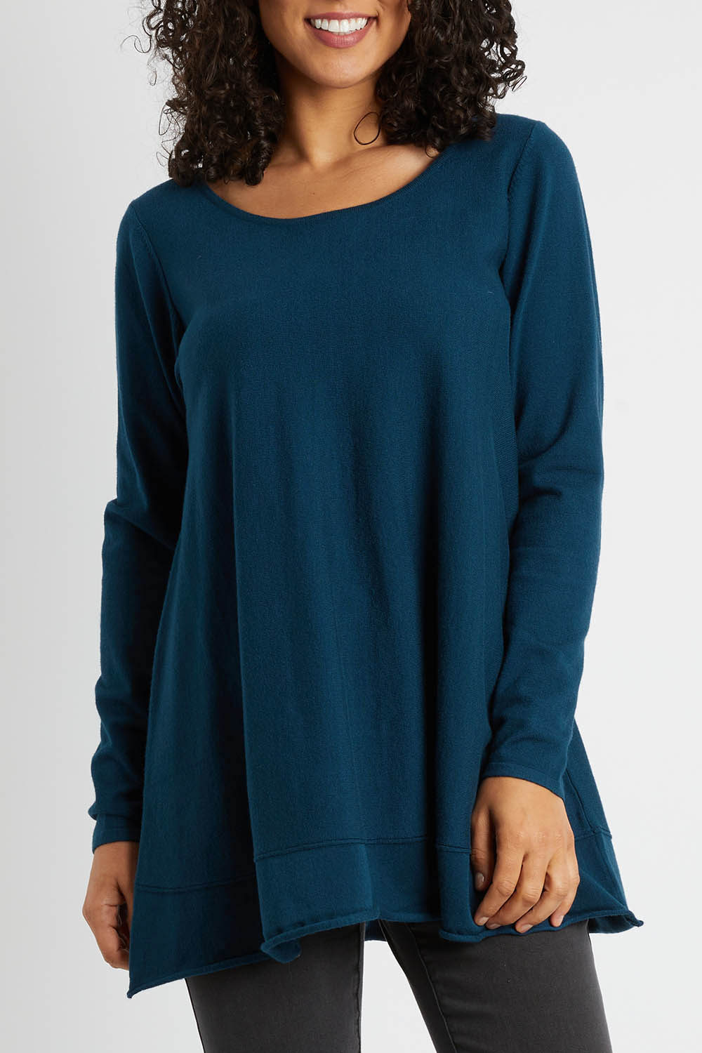 Model Pamela wearing size S of The Swing Knit in colour Petrol (Blue), from the front, cropped image