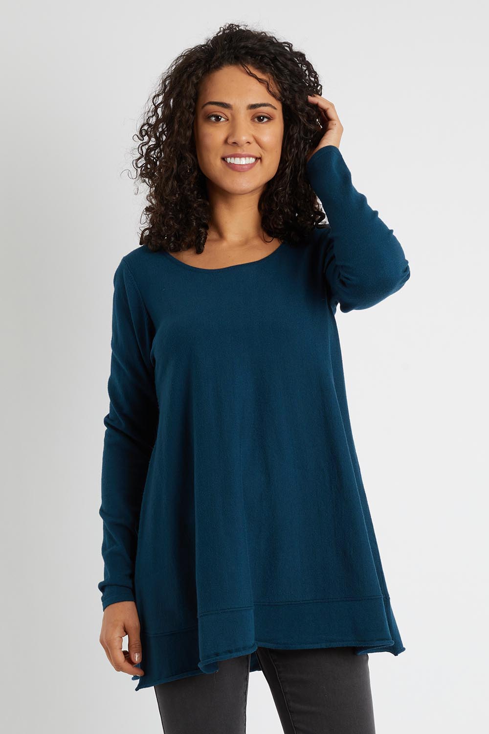 Model Pamela wearing size S of The Swing Knit in colour Petrol (Blue), from the front, cropped image