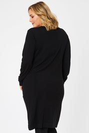 Model Jess wearing size L of The Pocket Detail Dress in colour Black (Black), from the back