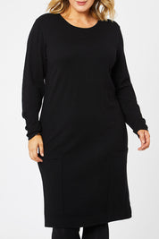 Model Jess wearing size L of The Pocket Detail Dress in colour Black (Black), from the front, cropped image