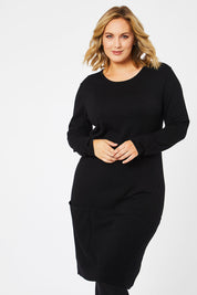 Model Jess wearing size L of The Pocket Detail Dress in colour Black (Black), from the front, cropped image