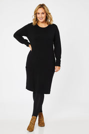 Model Jess wearing size L of The Pocket Detail Dress in colour Black (Black), from the front, showing the whole outfit