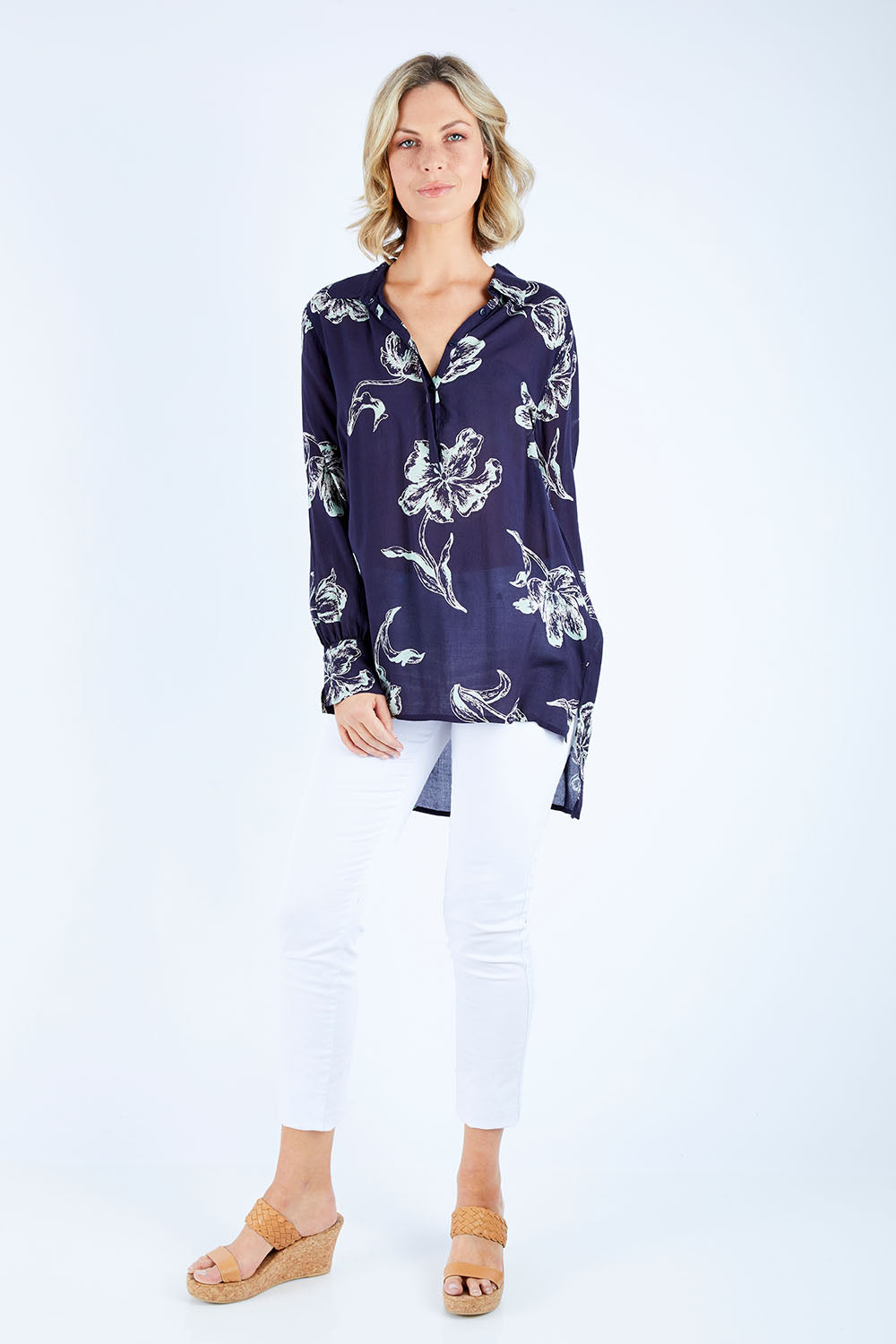 Model Chelsea wearing size 10 of The Longline Button Shirt in colour Navyprint (Blue), from the front, showing the whole outfit