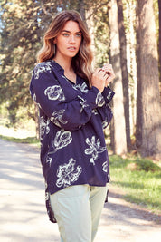 Model Laura wearing size 14 of The Longline Button Shirt in colour Navyprint (Blue), from the front, showing the whole outfit