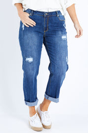 Model Laura wearing size 14 of The Distressed Boyfriend Jean in colour Mediumblue (Blue), from the front, cropped image