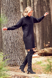 Model Chelsea wearing size S of The Roll Neck Tunic Dress in colour Black (Black), from the front, showing the whole outfit