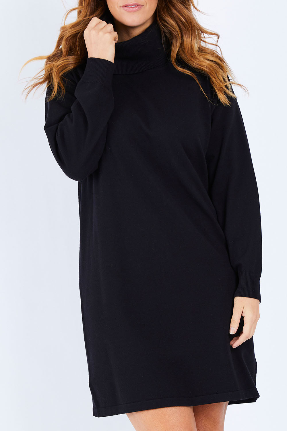 Model Laura wearing size L of The Roll Neck Tunic Dress in colour Black (Black), from the front, cropped image